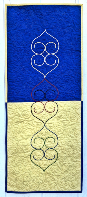 Hand embroidered quilt with Ukraine colors.