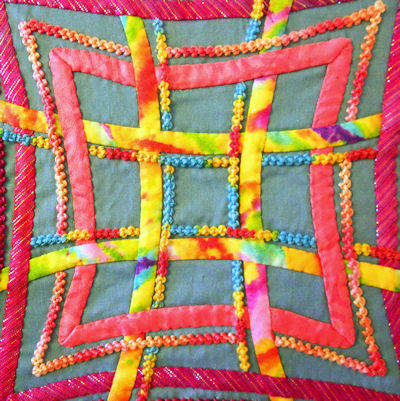 Center closeup of the hand embroidered and hand appliqued Aine knot.