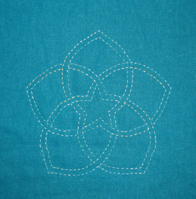 Sashiko Starflower on teal with varigated thread.