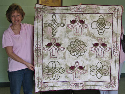 Jan Meadows with the Celtic quilt she won.